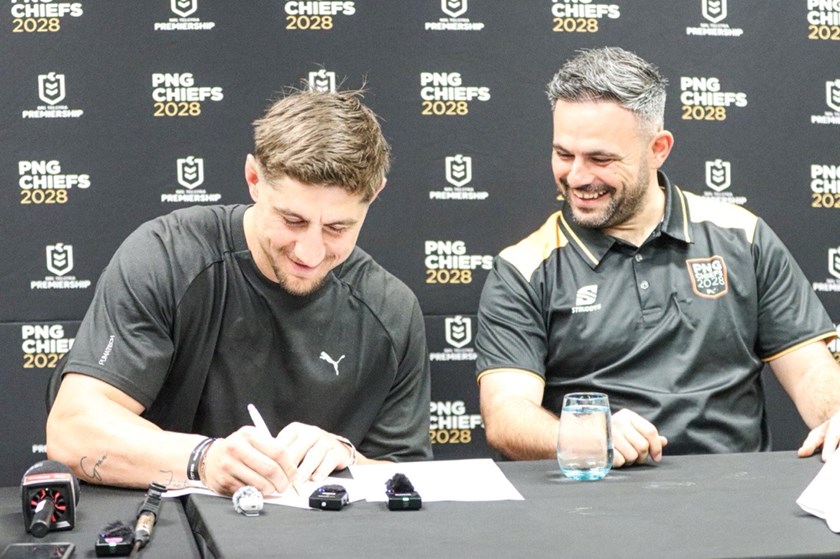 Zac Lomax officially signs a three-years contract with PNG Chiefs while the club's GM of Football Michael Chammas looks on.