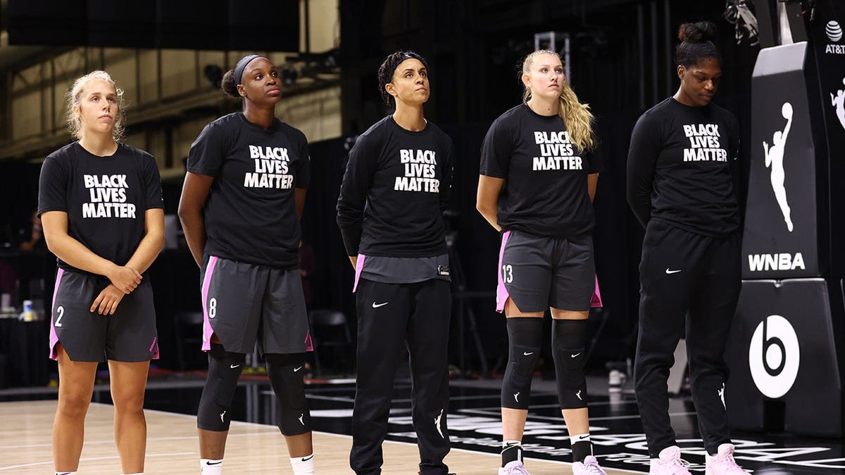 Indiana Fever players stand before a game against the Chicago Sky in Palmetto, Florida.