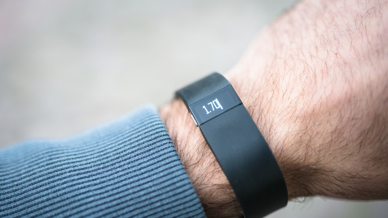 A person wearing a Fitbit fitness tracker.