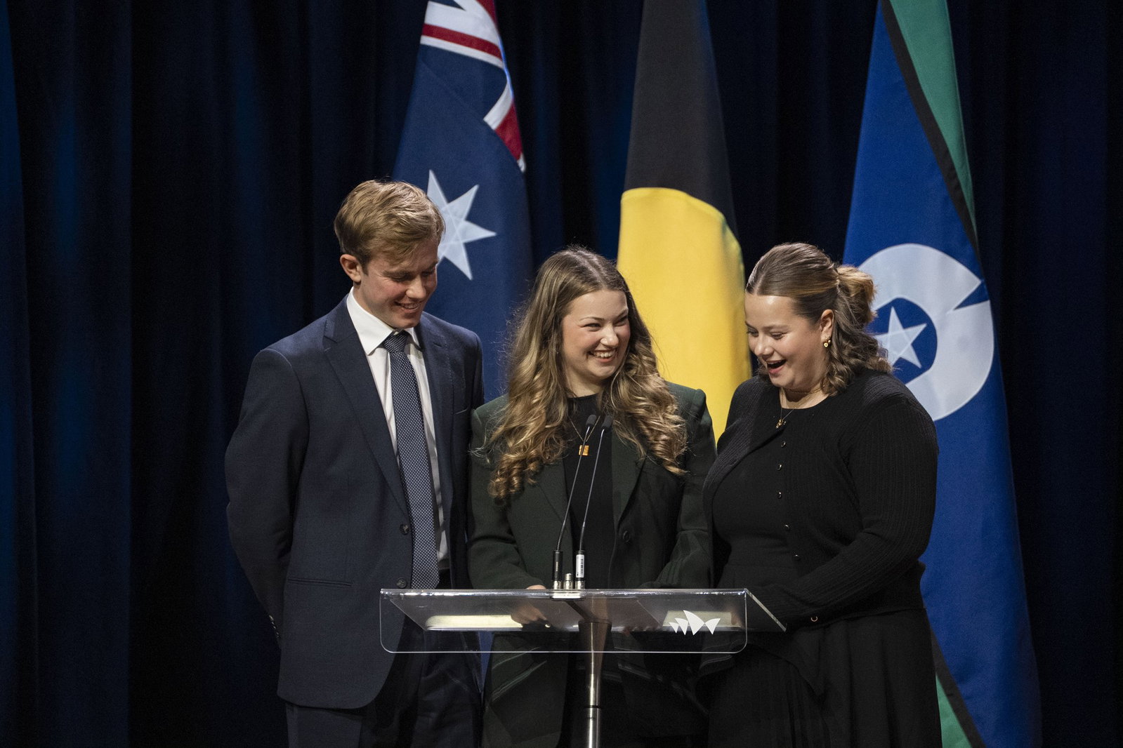 Emily, Matthew and Lucy Scolyer on stage speaking
