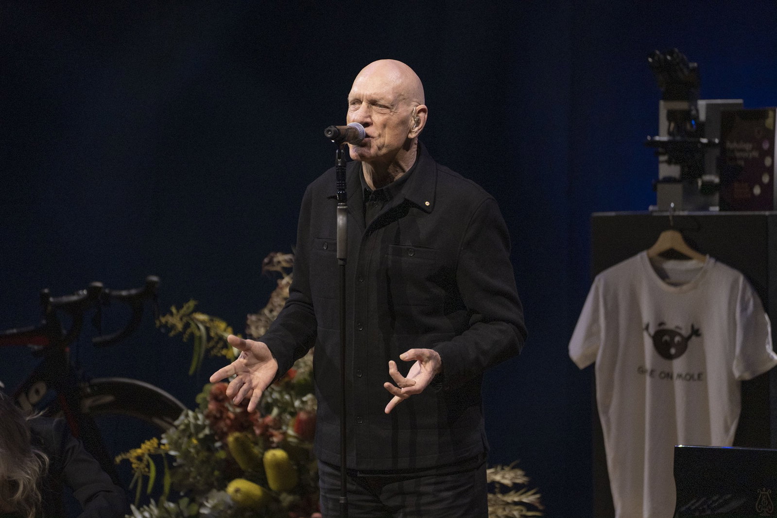 Peter Garrett singing in a black suit.