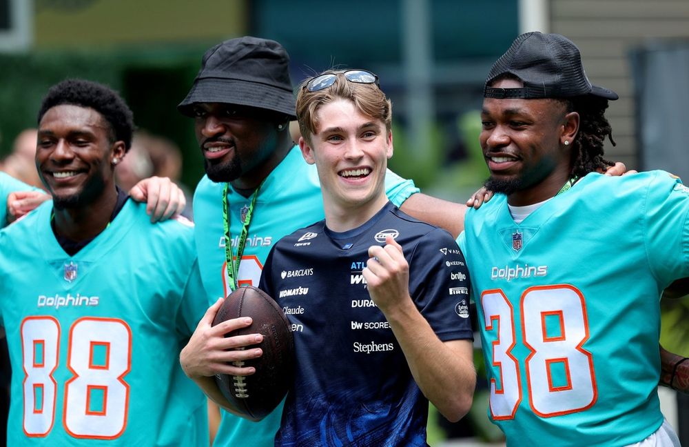 Luke Browning with Miami Dolphins players AJ Henning and Ethan Robinson. 