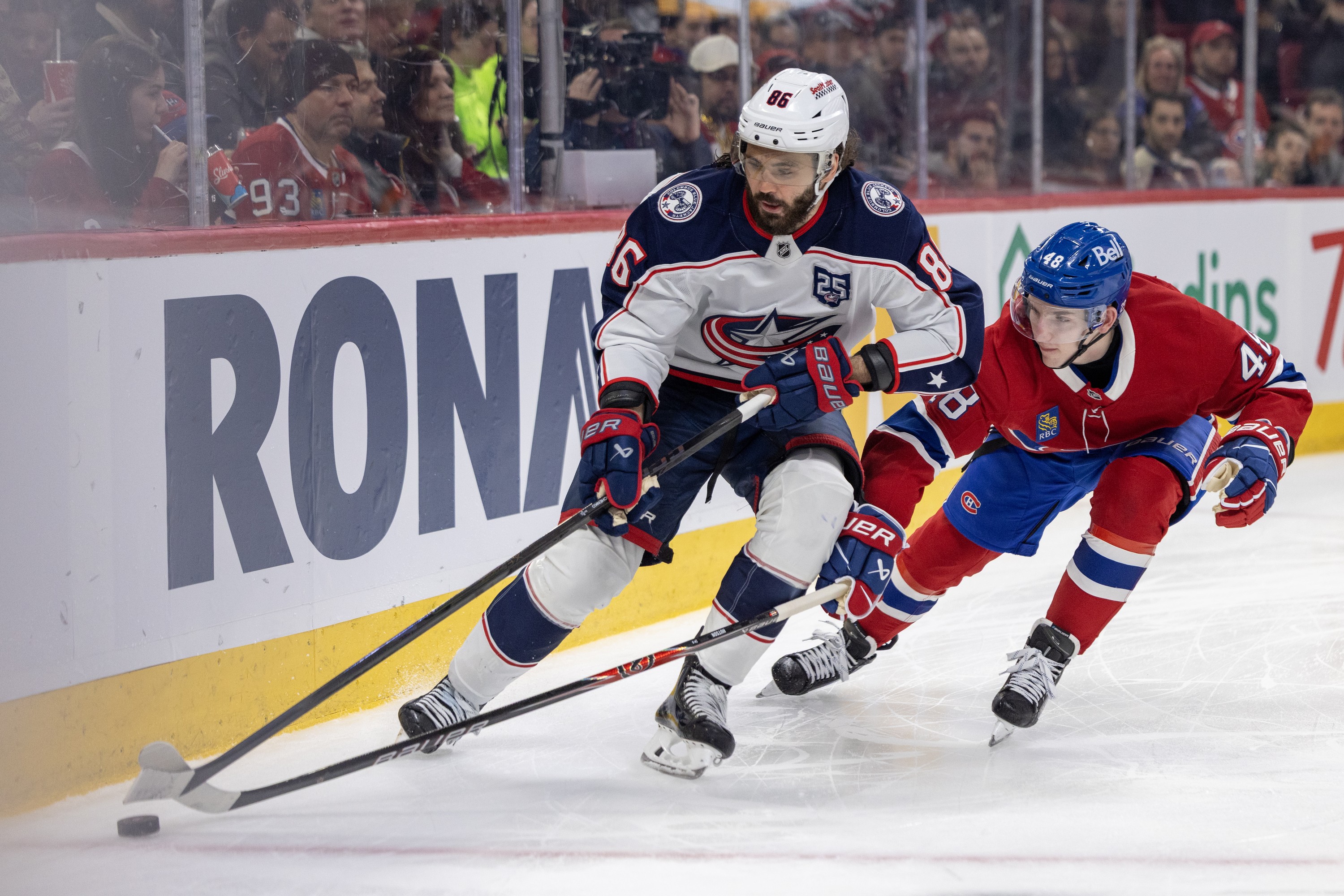 Canadiens defenceman Lane Hutson tries to lift stick of Columbus Blue Jackets' Kirill Marchenko in Montreal on March 26.