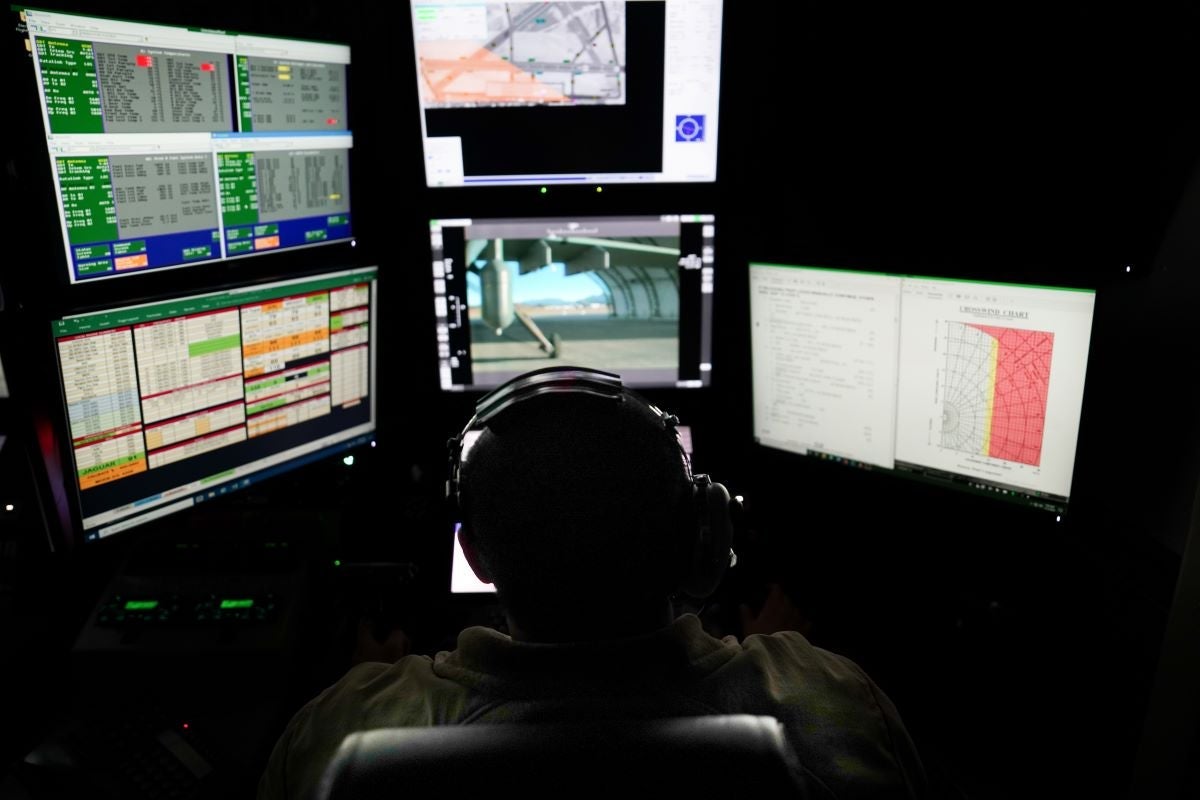Pictured is a U.S. Air Force photo of an MQ-9A sensor operator with the 11th Attack Squadron inside a ground control station at Creech AFB, Nev. on Nov. 7, 2024.