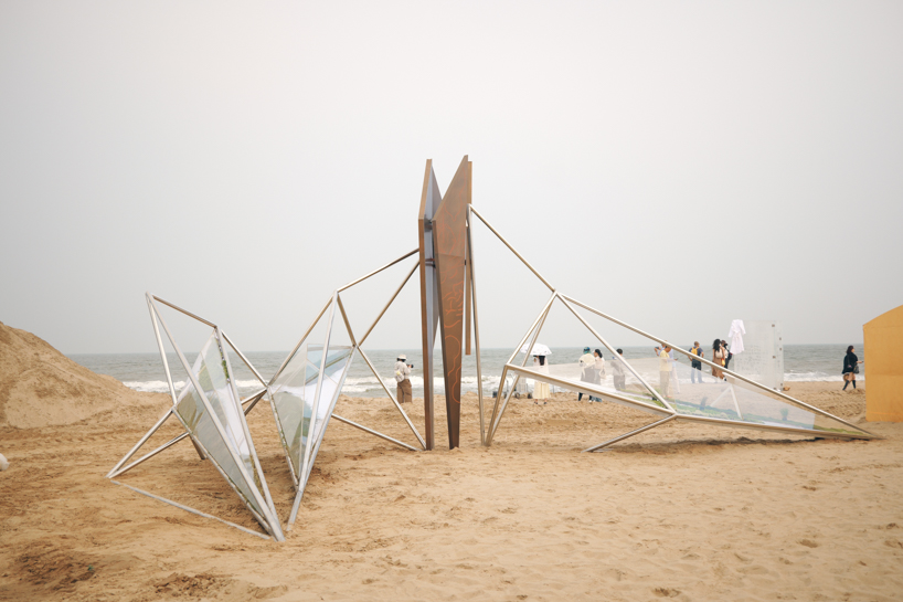 interconnected metal rods form a luminous winged installation on china's coastline - 1