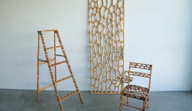 a carved wood ladder, door, and chair with irregularly shaped holes