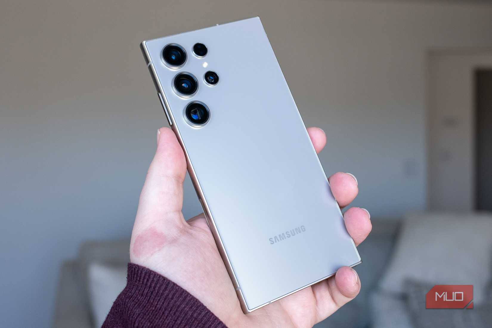 Person holding the Samsung Galaxy S24 Ultra showing the rear cameras