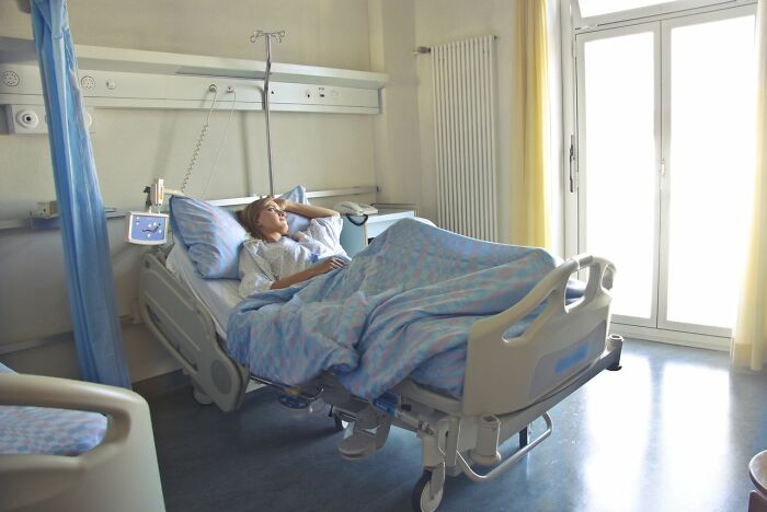 A patient lying in a hospital bed, illustrating a common scenario for ER staff.