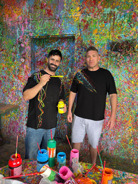Israeli Druze artist Sam Halaby, left, creates a custom painted T-shirt for a visitor during an impromptu demonstration at his House of Colors in Daliyat al-Karmel (Photo: Yael Feldman Shavit) Israeli Druze artist Sam Halaby, left, creates a custom painted T-shirt for a visitor during an impromptu demonstration at his House of Colors in Daliyat al-Karmel