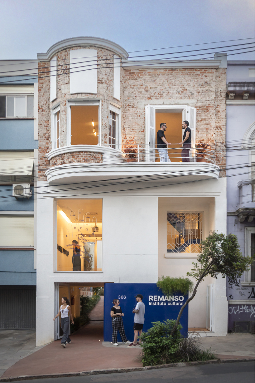 exposed brick and blue metal transform a 1930s brazilian house into a cultural art hub - 1