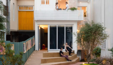 exposed brick and blue metal transform a 1930s brazilian house into a cultural art hub