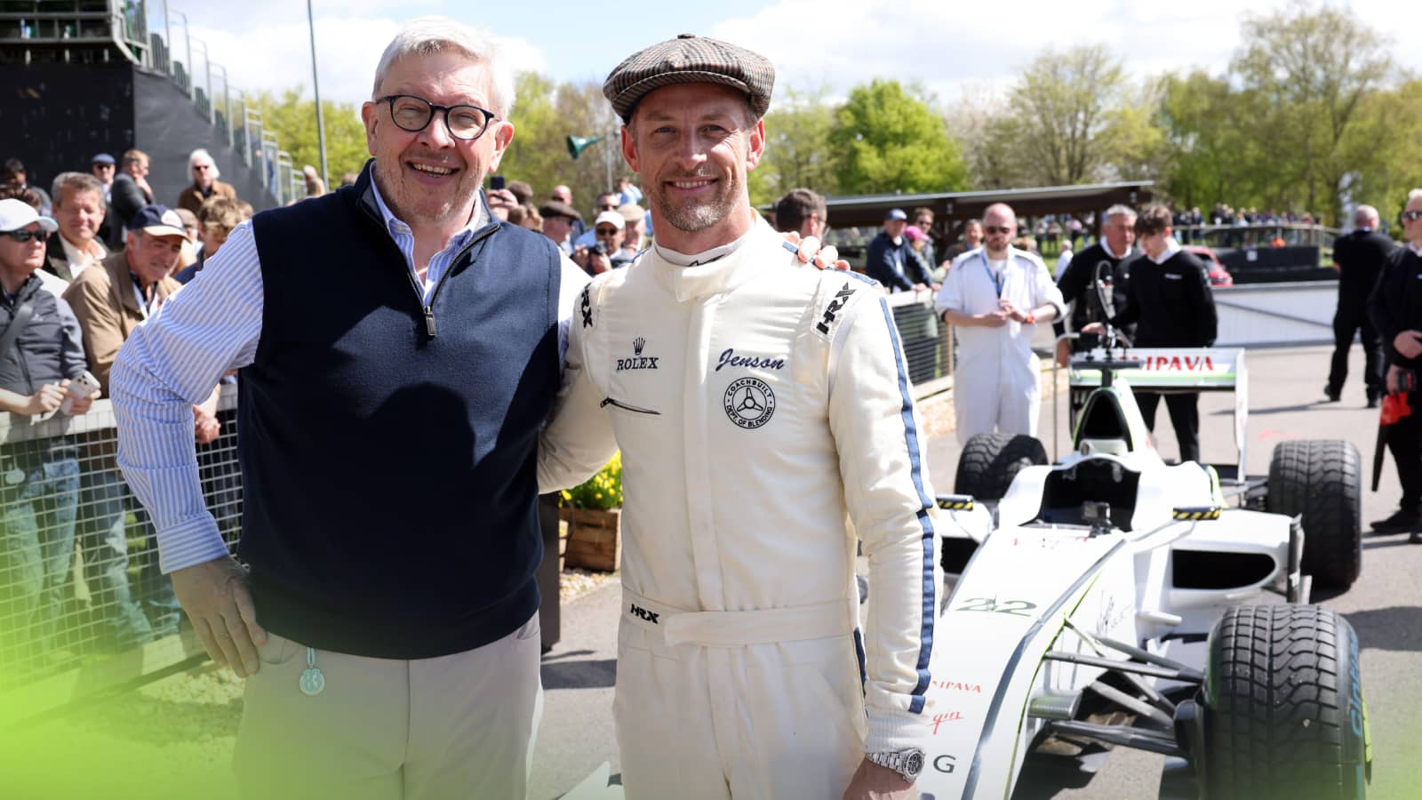 Ross Brawn and Jenson Button pose arm in arm in front of the Brawn GP 001 car at Goodwood