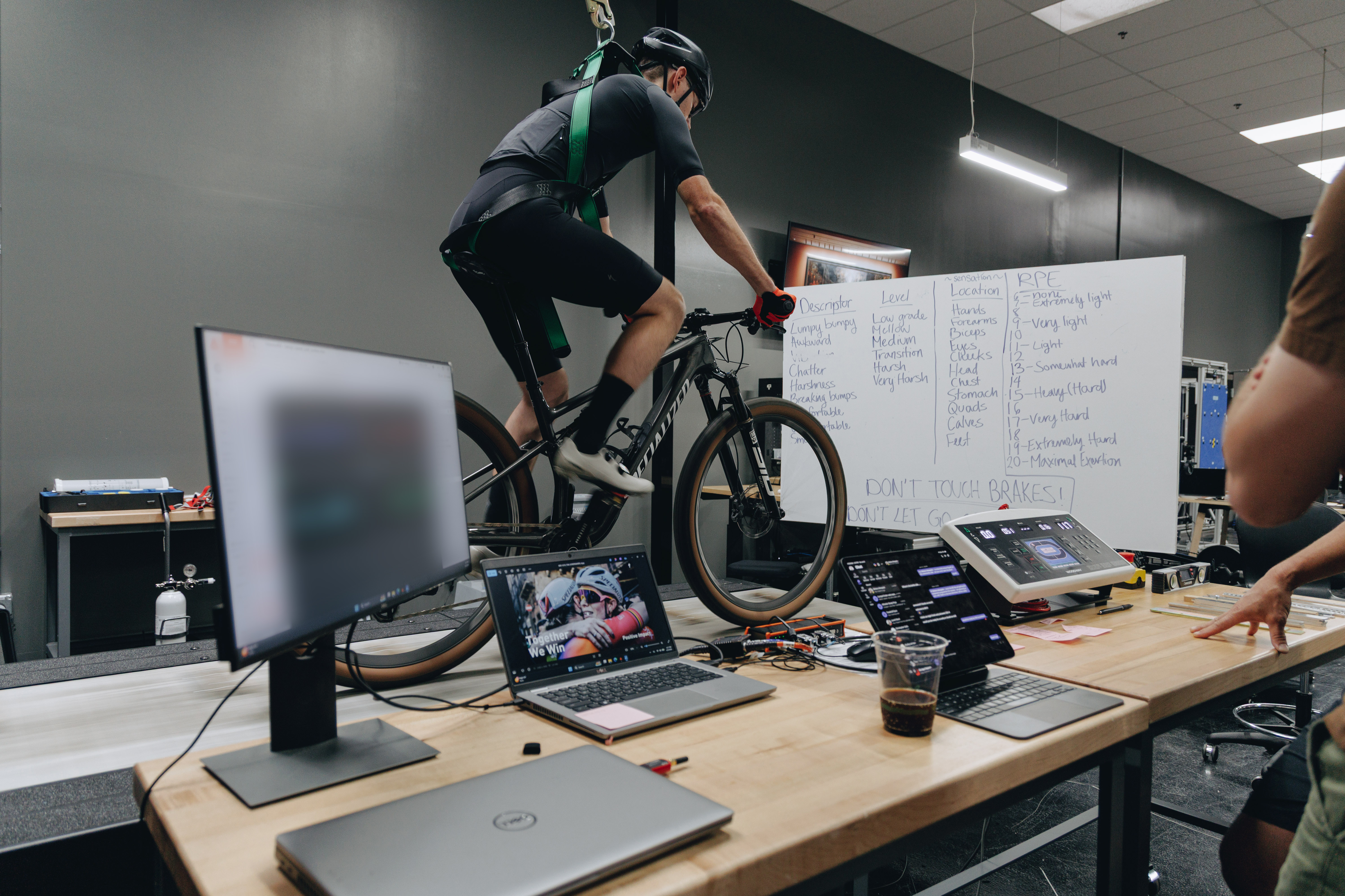 A rider on a mountain bike pedals on a treadmill