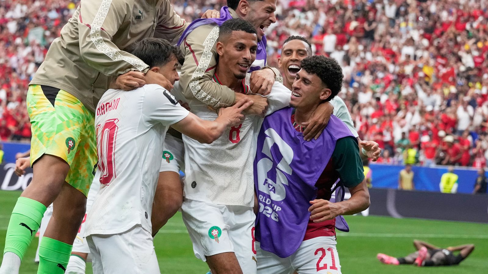 Morocco's Azzedine Ounahi is mobbed by team-mates after scoring second goal against Canada (AP Photo/David J. Phillip)