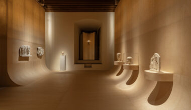 sculptural exhibition design traces a glowing path through antiquity