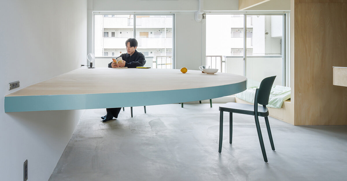 giant blue-green semicircular table by tato architects reorganizes kyoto apartment