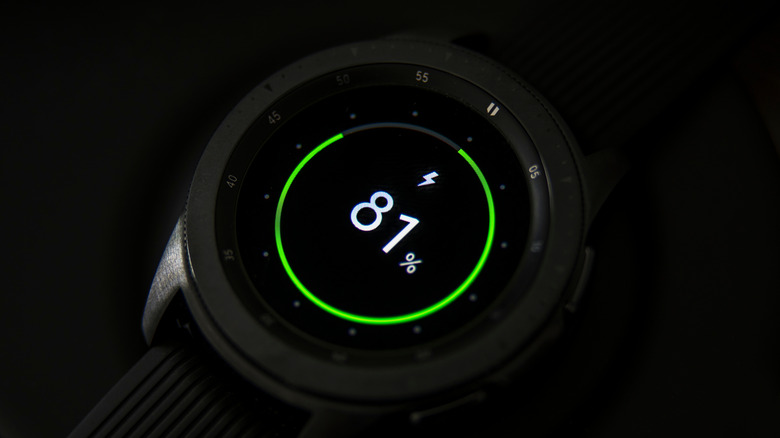 Closeup of a Samsung Galaxy watch charing on its wireless charging adapter