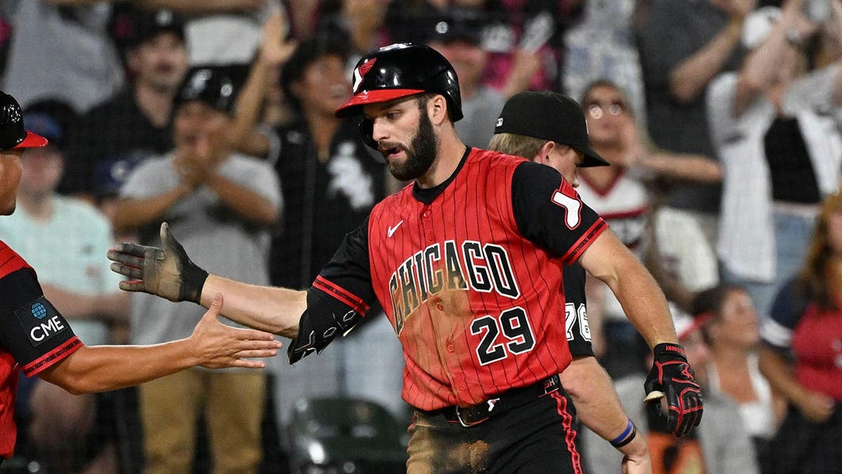 Tristan Peters high-fives Justin Jirschele at Rate Field.