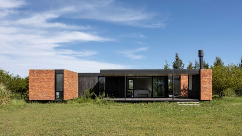 monolithic brick volumes wrap weekend house around a series of courtyards in argentina - 2