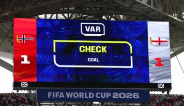 A large screen shows results during a FIFA World Cup match