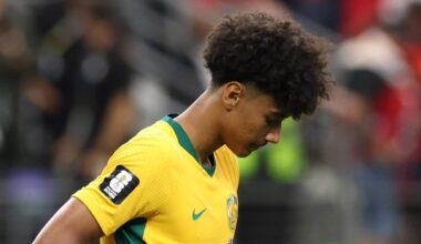 Socceroos player ooks down while lifting the front of his jersey after Australia's World Cup round-of-16 loss to Egypt.