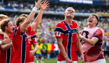 Norwegian footballer Erling Haaland, dressed in Norway's red white and blue uniform, celebrates a goal with his team mates.