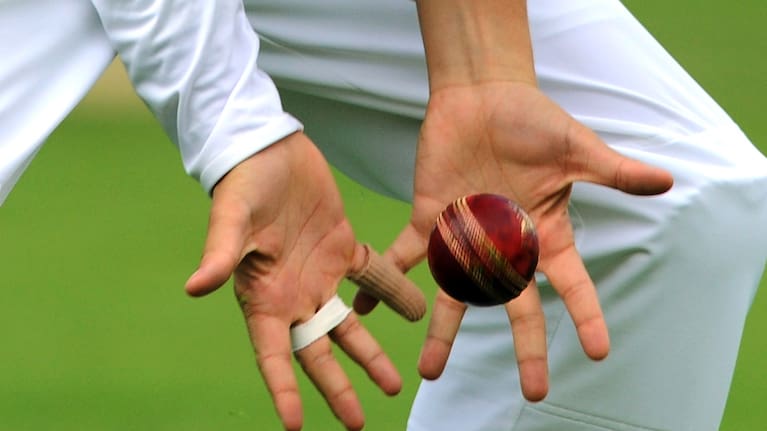 View of cricketer's hands catching a cricket ball during day four of the first Ashes Test cricket match, in Cardiff, Wales.