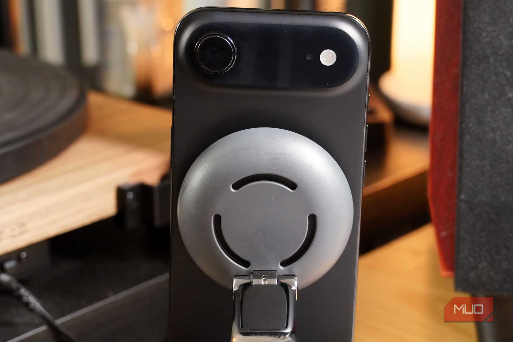 Wireless charger with a cooling fan connected to an iPhone Air.
