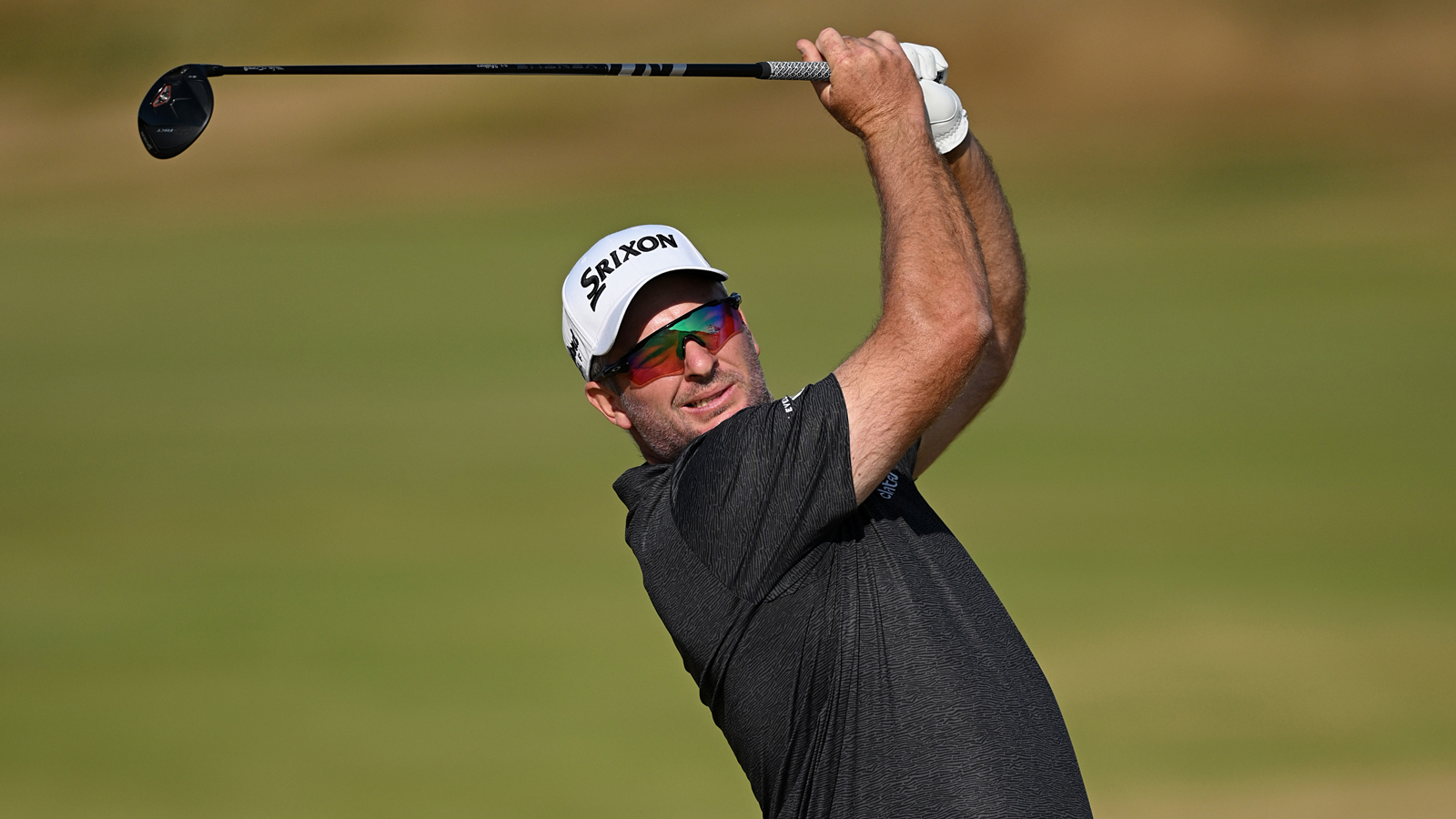 Ryan Fox hits a fairway wood and watches the flight of it