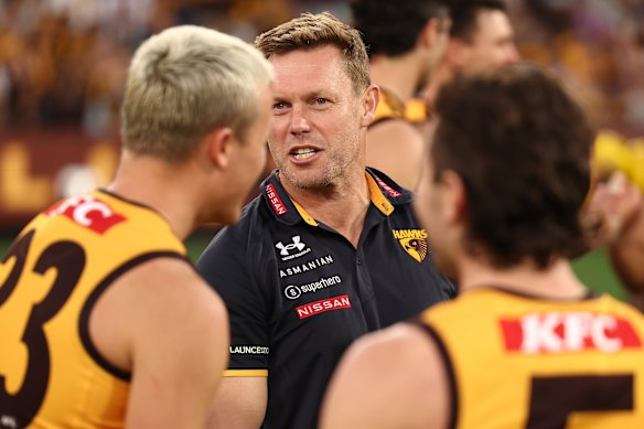 Hawthorn coach Sam Mitchell addressing Ginnivan and star teammate Nick Watson.
