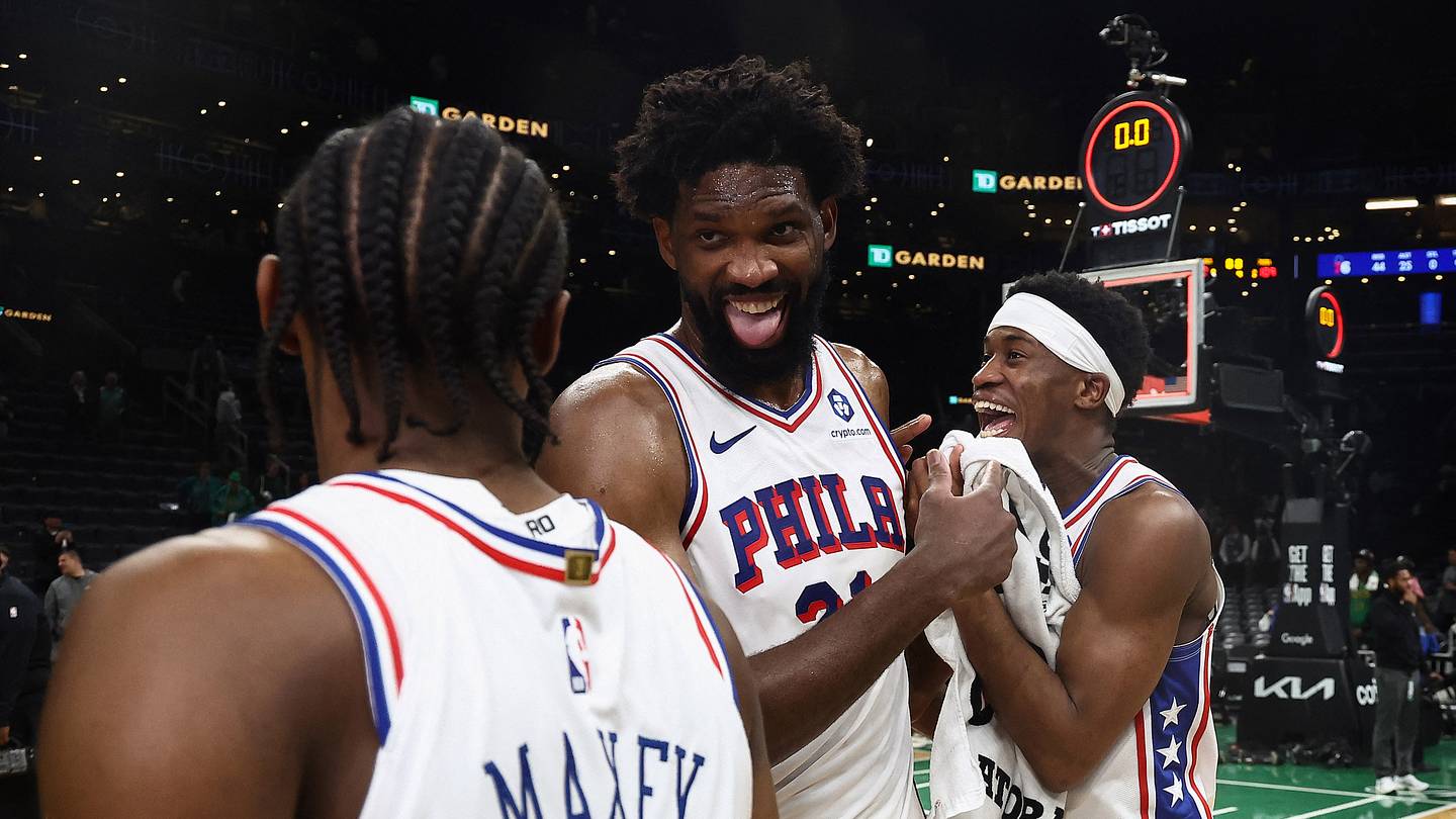 Philadelphia 76ers center Joel Embiid (21) celebrates with guard Tyrese Maxey (0) and guard Vj Edgecombe (77)] following their win over the Boston Celtics in game seven of the first round of the 2026 NBA Playoffs at TD Garden.