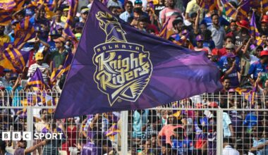 A Kolkata Knight Riders fan waves a big flag