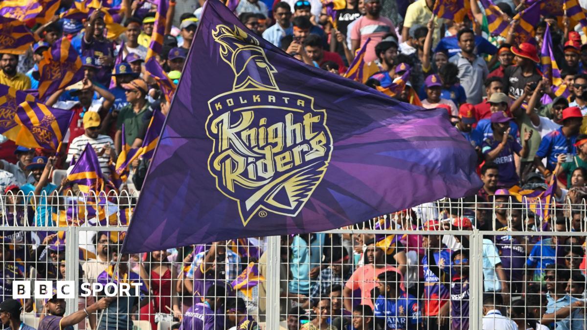 A Kolkata Knight Riders fan waves a big flag