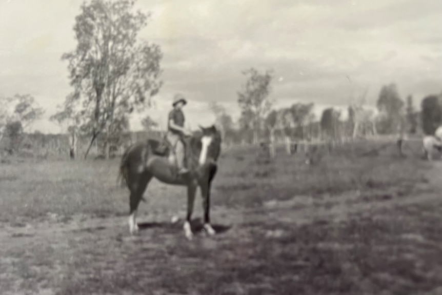 old black and white photo of a young man on horseback