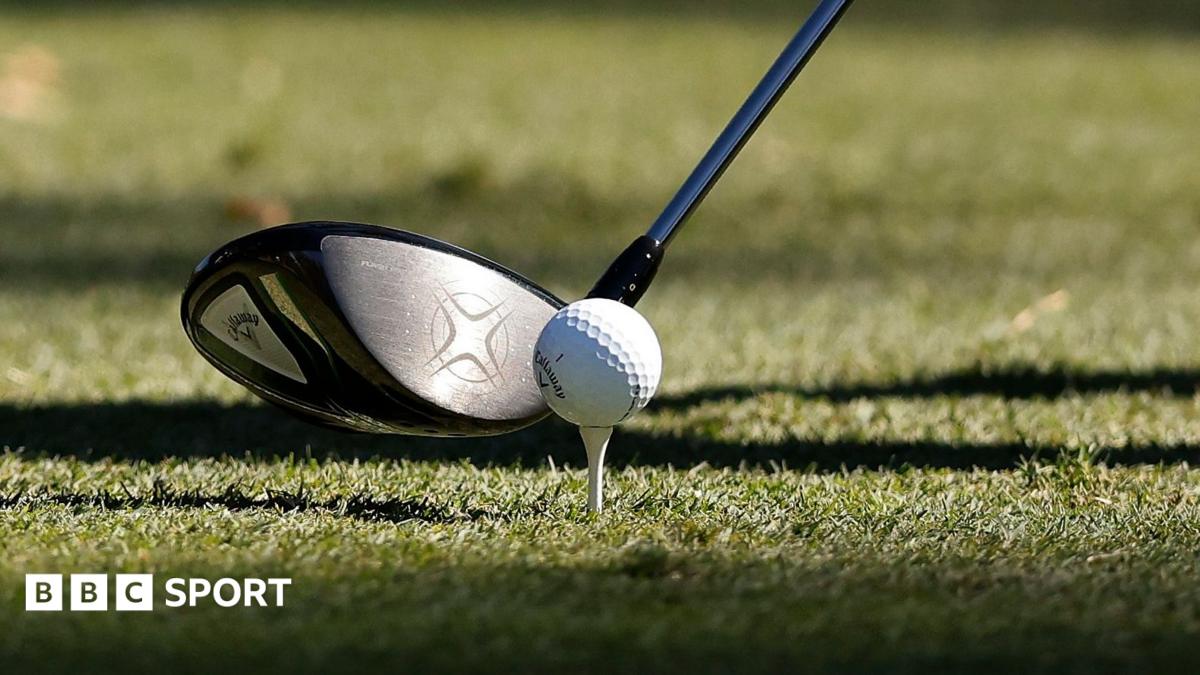 An image of a golf club and golf ball on a tee