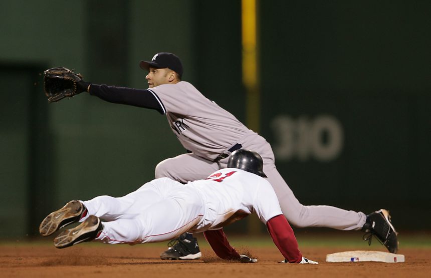 Dave Roberts (#31) of the Red Sox steals second base while shortstop Derek Jeter (#2) of the New York Yankees during game four of the ALCS.