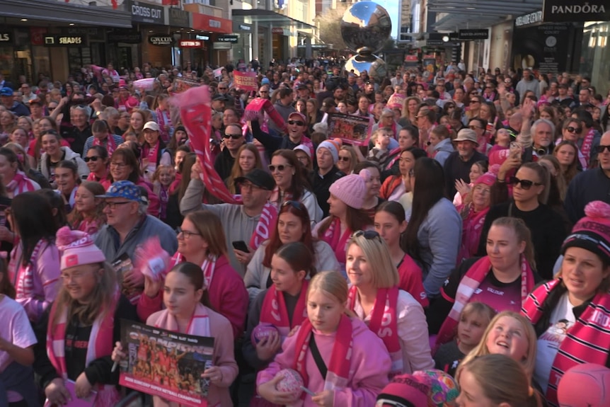 Hundreds of people dressed in pink