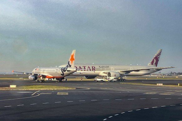A Jetstar and a Qatar Airways plane came within metres of colliding on the tarmac at Sydney Airport.