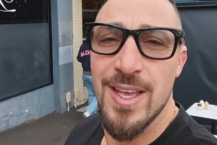 A man with a beard wearing glasses.
