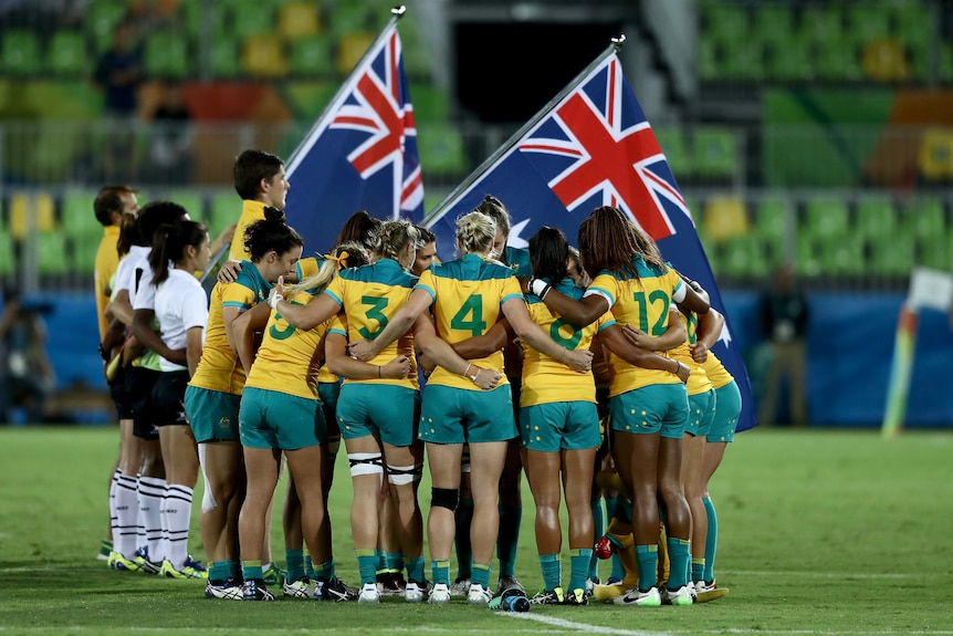 Australia in a huddle before the start of the women's rugby sevens gold medal match at the 2016 Rio Olympics.