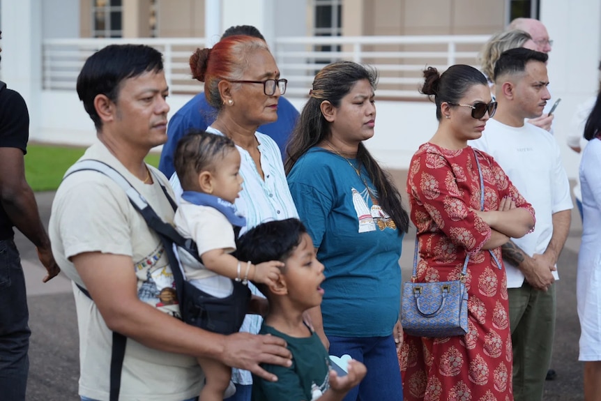 A group of adults with a child and baby