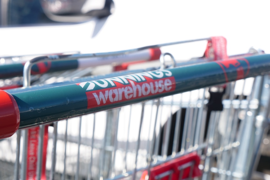 A close up of the handle of a Bunnings shopping trolley.