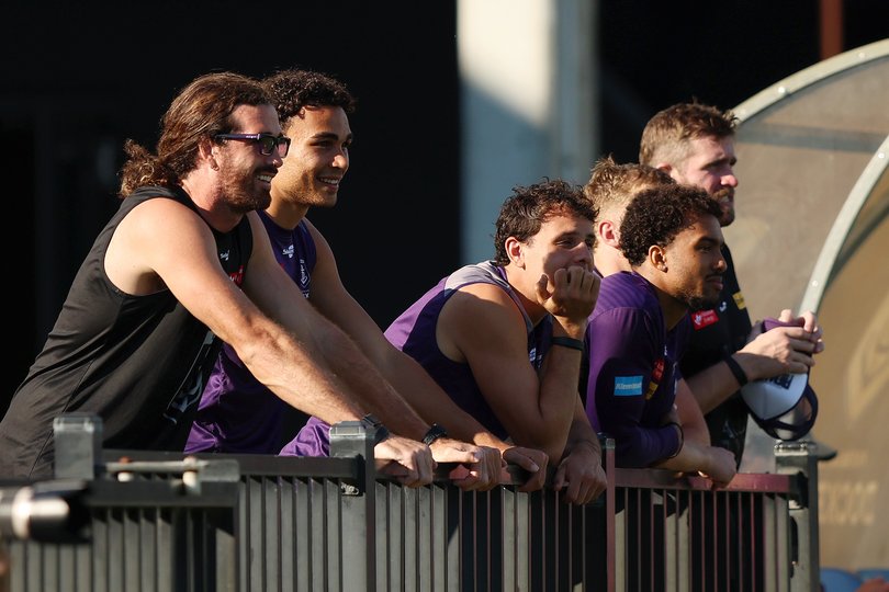 Alex Pearce and teammates watching the AFLW clash.