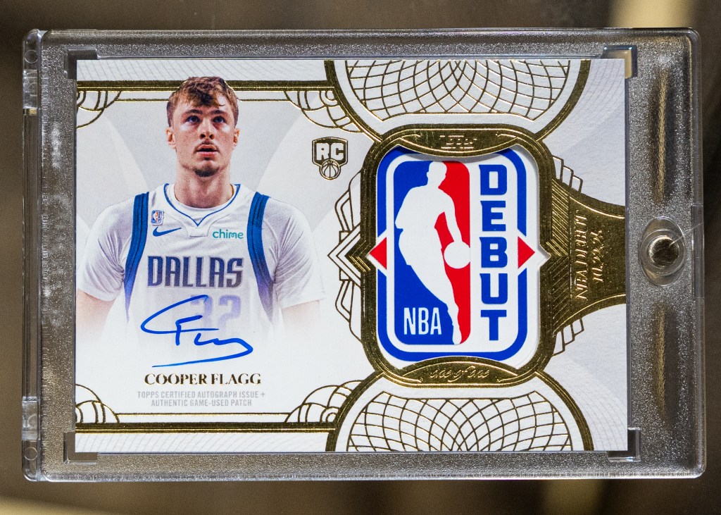 Basketball trading card featuring Cooper Flagg in a Dallas jersey with his autograph and an NBA Debut logo.