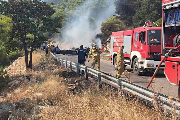 Firefighters work at the site of the crash.