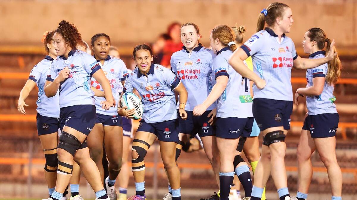 Waratahs celebrate a try scored by playmaker Waiaria Ellis. (Mark Kolbe/AAP PHOTOS)
