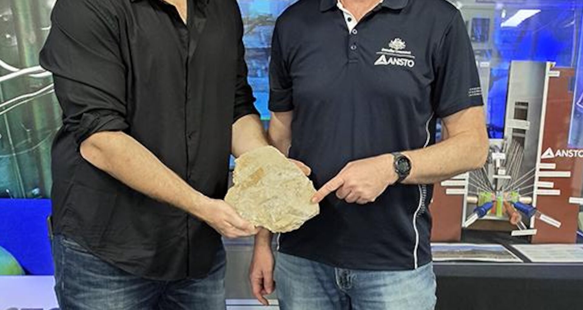 Researchers holding a fossil.