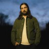 The Great Divide, Noah Kahan's fourth album, is a prodigal son fable, with a central character who destabilizes the spaces he once called home.