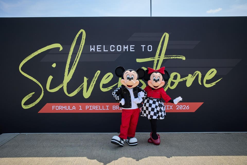 Mickey and Minnie in front of Silverstone sign. 