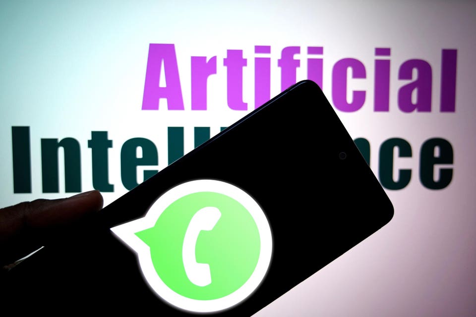 Whatsapp logo is seen displayed on a smartphone with the words 'Artificial Intelligence' in the background.